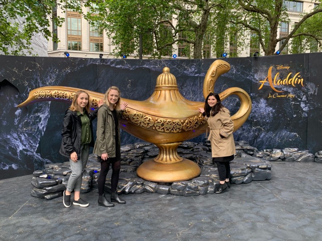 Jocelyn Bankson, Kayla Snyder and Angela Altieri pose with The Lamp from Disney's Aladdin. 